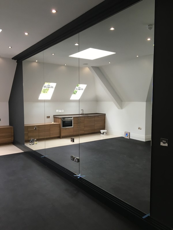 Frameless glass partition in loft conversion by Abingdon glaziers