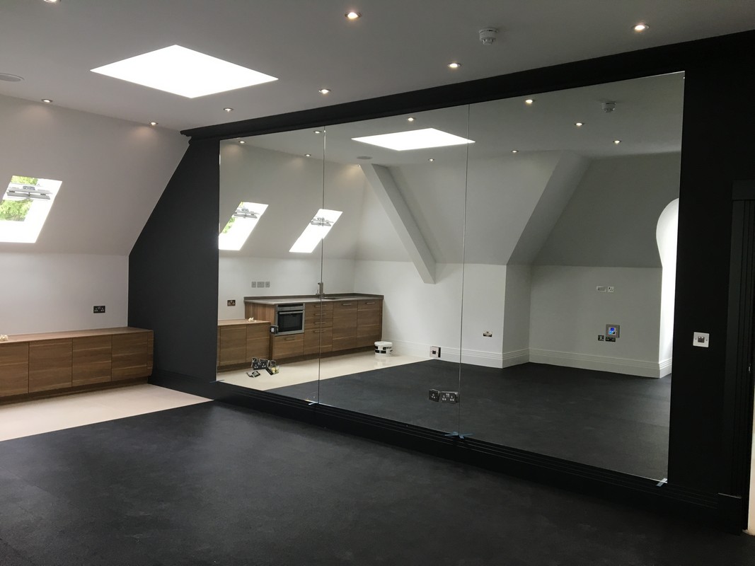 Frameless glass wall dividing loft conversion in Abingdon